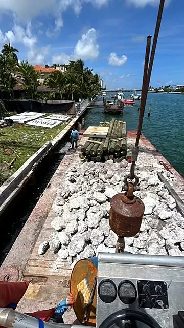 Work barge loaded with stone on a Miami waterway