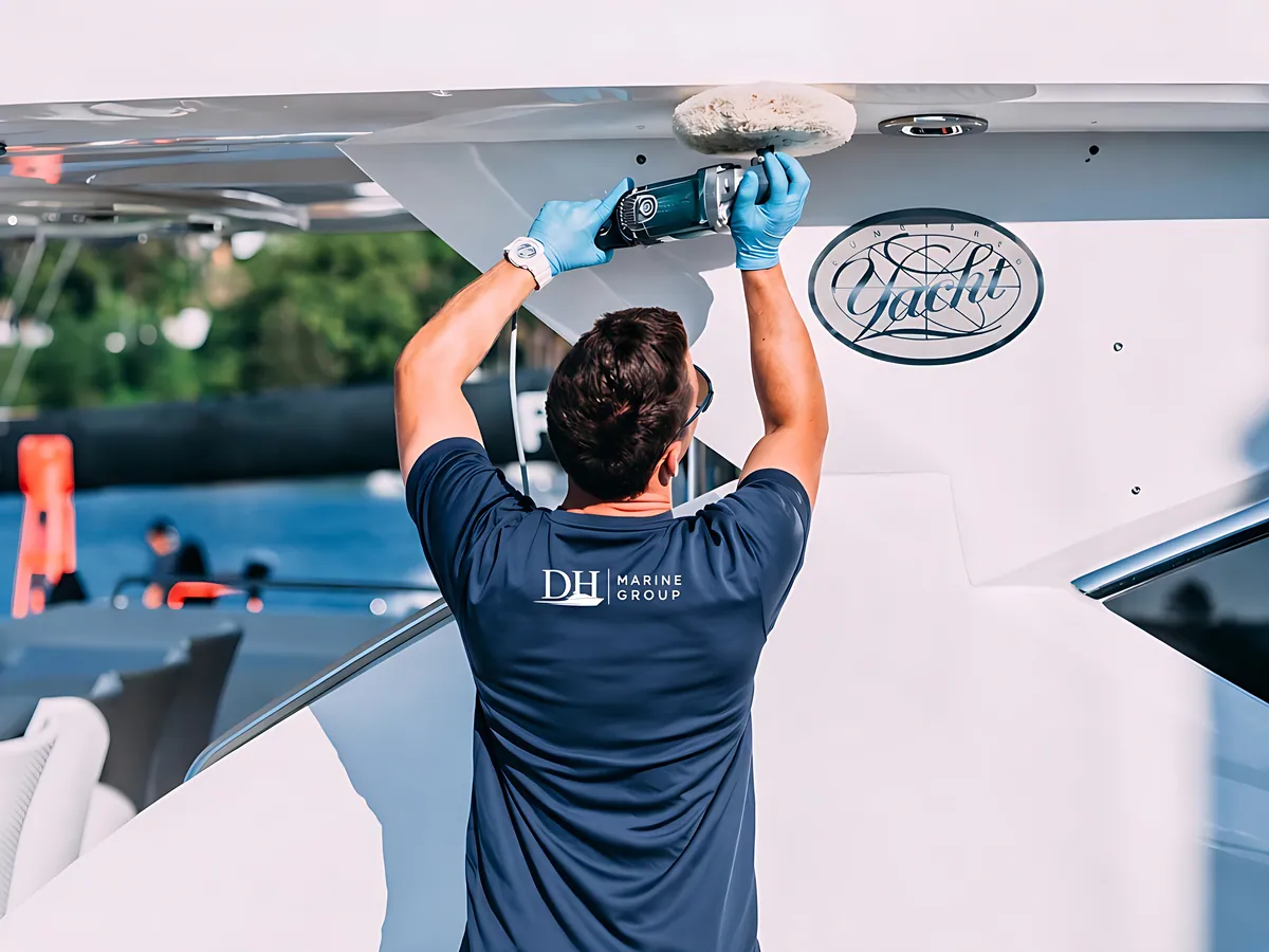 D.H. Marine technician polishing a yacht hull